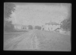 [Kansas] Photograph of wagon tracks on a dirt road leading through town