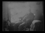 [Kansas] Photograph of a man sitting in a rocking chair