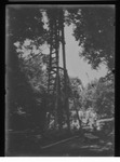 [Kansas] Photograph of three men standing by a tall tower