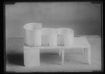 [Kansas] Photograph of three cylindrical cans used as props