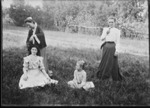 [Kansas] Photograph of two women standing and two girls sitting down