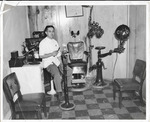 [Brownsville] Photograph of Dr. Melchor Landin, Jr. in his optometrist office