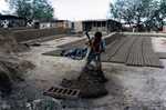 [Reynosa, CAV-Arriaga] Photograph of Brick Molder Mixing Clay with a Hoe by Scott Cook