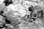 [Reynosa, CAV-Arriaga] Photograph of Brick Molder Working While Child Plays Nearby by Scott Cook