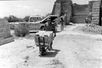 [Reynosa, CAV-Arriaga] Photograph of a Tano's Son Hauling Bricks by Wheelbarrow from a Kiln by Scott Cook