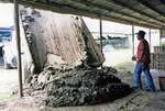 [Reynosa, CRG] Photograph of a Worker Preparing to Remix and Knead Wet Clay by Scott Cook