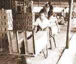 [Reynosa, CRG] Photograph of Workers Transporting and Stacking Dried Unfired Bricks by Scott Cook
