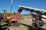 [Reynosa, ELL-New] Photograph of a Raw Clay Conveyor with Stacked Fired Bricks by Scott Cook