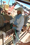 [Reynosa, ELL-New] Photograph of a Pug Mill Operator Watering a Clay Mixture by Scott Cook