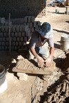 [Reynosa, ELL-New] Photograph of Manuel Pasilla Hand-Packing Wet Clay into a Mold by Scott Cook