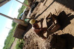 [Reynosa, ELL-New] Photograph of Juan Garza Hand-Packing a Brick Mold with Wet Clay by Scott Cook