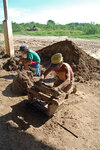[Reynosa, ELL-New] Photograph of Juan Garza Scraping Excess Clay from a Filled Mold by Scott Cook
