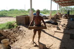 [Reynosa, ELL-New] Photograph of Juan Garza Holding a Mold Filled with Wet Clay by Scott Cook