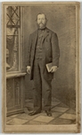 Middle aged man standing with a book in one hand, front by Joshua A. Williams