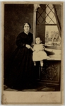 Woman in black dress and child in white dress, front
