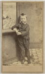 Boy in dark suit with elbow propped up, front by J.D. Fowler & Co.