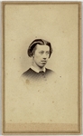 Young woman with short hair parted down the middle and curled into itself, looking right, pattern dress, half portrait, front