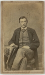Young man in a long overcoat, sitting next to a table, front by B. D. Boardman