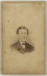 Man in dark suit with hair combed rear, half length portrait, front