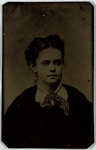 Young woman in dark dress with necklace and earrings, front