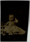 Baby with white bead necklace, one arm upturned, front