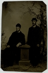 Two men in black garb, facing left, full-length portrait, front