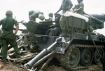 Photograph of U.S. Army Soldiers ready to load the M107 175 mm self-propelled gun by Cayetano E. Barrera