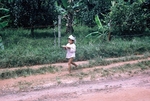 Photograph of a child carrying food by Cayetano E. Barrera