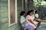 Women waiting outside a home