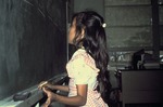 Young girl writing on chalkboard