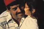 Young girl kissing her father on cheek