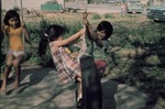 Young children having fun with tire swing