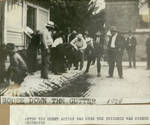 Page 58, Alcohol being poured down gutter during prohibition by John R. Peavey