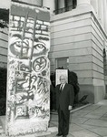 Photograph of Kika de la Garza beside a section of the Berlin Wall known as Bloody Erich