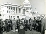 Photograph of Kika de la Garza speaking at a press conference in front of United States Capitol