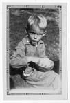 [People] Photograph of young boy eating out of a coconut