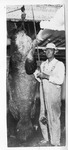 [South Padre Island] Photograph of fisherman next to large grouper