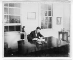 [People] Photograph of unidentified man seated at office desk