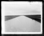 [Agriculture] Photograph of Dirt Canal with two people