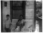 Photograph of young Rene Torres, his mother, and young sibling
