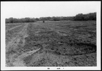Photograph of a field with man-made holes