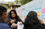 [Dream Rally] Photograph of Students Writing Dreams on Whiteboard by University of Texas at Brownsville and Paul Chouy
